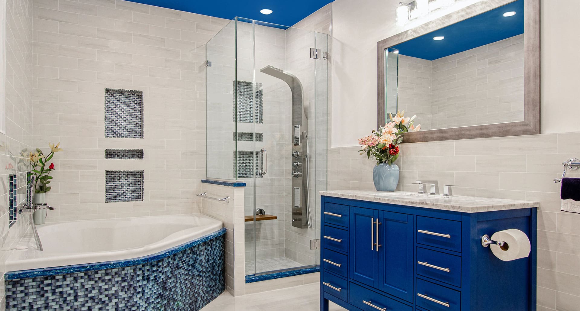 A bathroom with blue tile and white walls.